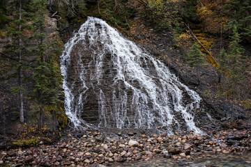 Mountain waterfall in the autumn forest. Jasper National Park, Alberta, Canada.
