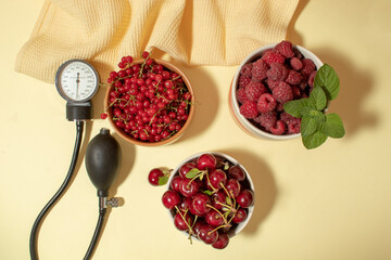 Red fruits of currants, raspberries and cherries in bowls. Health concept. Blood pressure