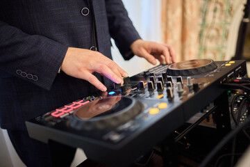 Witness the DJ mixing equipment performing live and in action at a vibrant music event