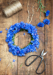 Top view of floral wreath made of beautiful fresh deep blue cornflowers (Centaurea cyanus)....