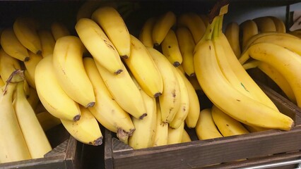 Fresh Bananas in a Wooden Box Display at a Market Ready for Customers to Purchase