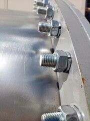 Detailed Close-Up of Flange With Bolts and Nuts in Industrial Setting Under Bright Sunlight