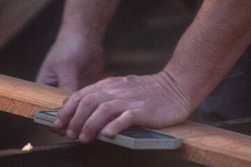 man building his hut with tools