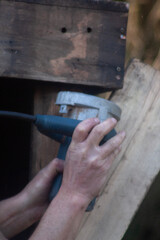 man building his hut with tools