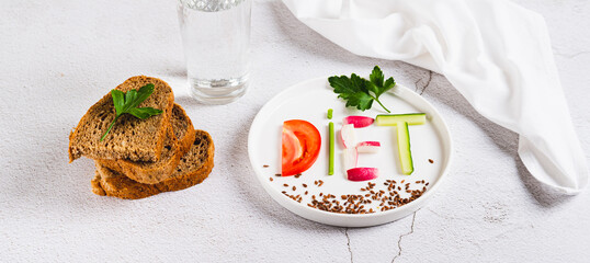 Concept diet on a plate of low-calorie foods on the table web banner