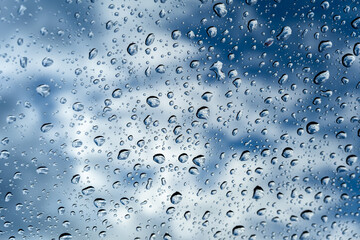 Water droplets on glass, dramatic cloudy sky
