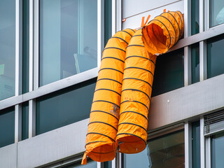 Orange Ventilation Ducts on Modern Building