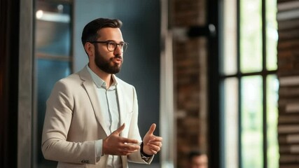Confident male speaker delivering a motivational speech to an attentive audience