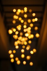 Bokeh lights background blurred glowing gold effect abstract holiday celebration design