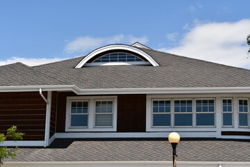 Narrow round window on rooftop.