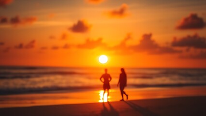Vibrant beach sunset scene with silhouettes of two figures in warm golden hues.