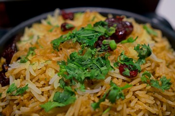 Close up of vegan biryani, featuring fragrant basmati rice, spices, herbs, and fried onions,...