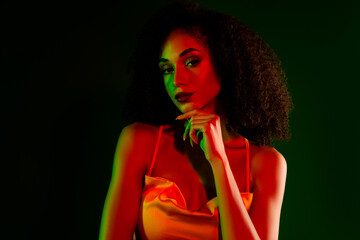 Luxurious young woman posing in a vibrant gradient background, showcasing stylish beauty