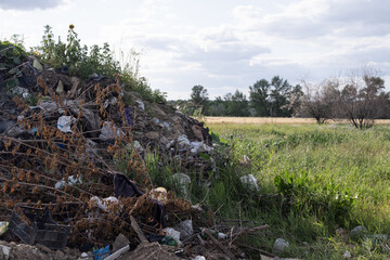 Illegal rural dump polluting a picturesque landscape with plastic waste