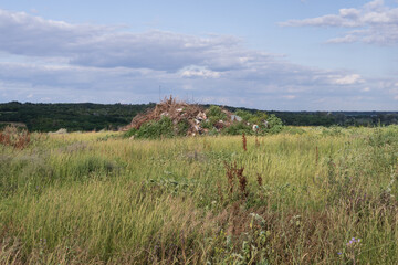 Illegal rural dump polluting a picturesque landscape with plastic waste