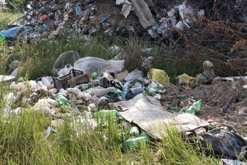 Illegal rural dump polluting a picturesque landscape with plastic waste
