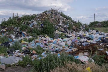 Illegal rural dump polluting a picturesque landscape with plastic waste