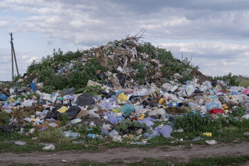 Illegal rural dump polluting a picturesque landscape with plastic waste
