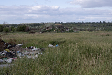 Illegal rural dump polluting a picturesque landscape with plastic waste