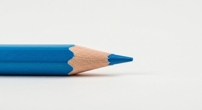 Close-up view of a sharpened blue pencil on a white surface, showcasing the details of the wooden texture and color. - Powered by Adobe