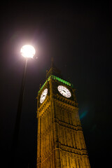 clock tower at night with street lamp london