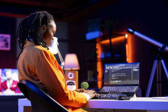 Freelancing admin in home office using laptop to write programming language code. Young software technician working from apartment using notebook device to build application