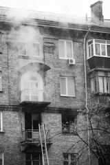 Fire in a five-story brick apartment building, firefighters entered the apartment via a ladder,...