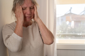 Elderly Woman Suffering from a Migraine