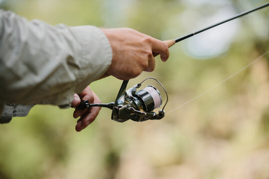 Fisherman holding fishing rod, waiting for fish to bite