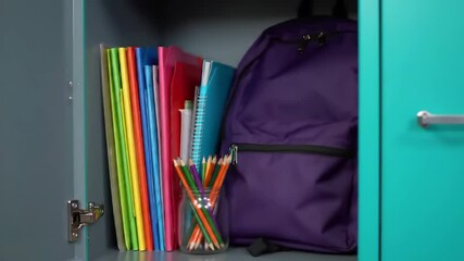 Opening school locker to reveal organized supplies and backpack in vibrant colors