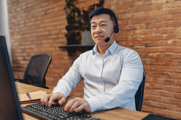 A dedicated call center agent is effectively engaging with clients through a headset in a modern...