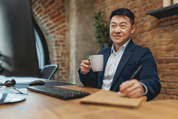 A devoted and committed professional relishes freshly brewed coffee while diligently working in a...