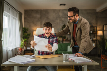 Young student read positive answer about scholarship from envelope