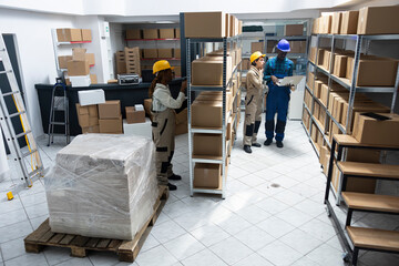 Diverse team of employees work in a storehouse for import export and distribution system, managing...