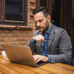 Adult man use laptop for work or browse internet in cafe restaurant