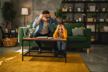 exhausted father help son to finish his homework
