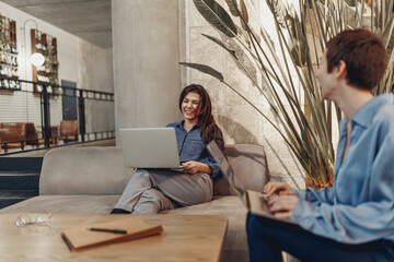Two professionals are engaged in a very productive discussion in a stylish and contemporary office...