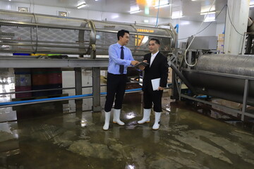 two businessmen meeting and discuss in food factory