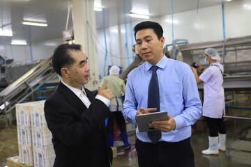 two businessmen meeting and discuss in food factory