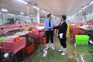 two businessmen meeting and discuss in food factory