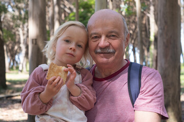 Elderly European Grandfather with a Mustache Posing with His Granddaughter