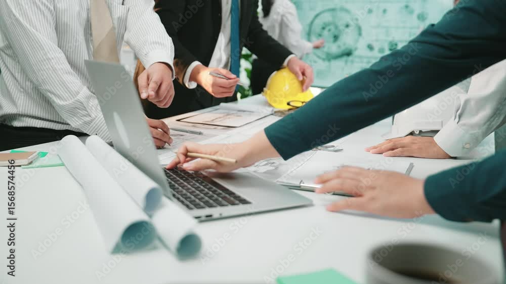Poster a diverse group of business professionals engage in a collaborative engineering design session at a 
