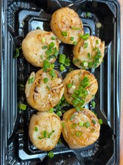 Fresh scallops with green onions at seafood market in Osaka, Japan