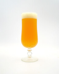 A closeup of a glass of pale ale isolated against a white background. 