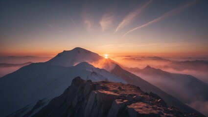A sunrise summit on a mountain with clouds and peaks at dawn.