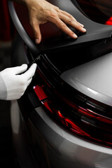 Vinyl Application in Progress in detailing. Vinyl film is trimmed with sharp blade to ensure...