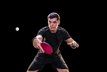Table tennis player focused in action during game on black background with intense expression and...