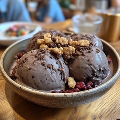 Chocolate ice cream scoops topped with a crumble.