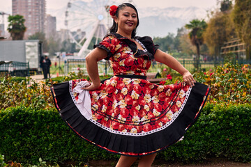 Portrait of a beautiful, smiling young woman, happily dressed in a Chilean huasa, celebrating,...