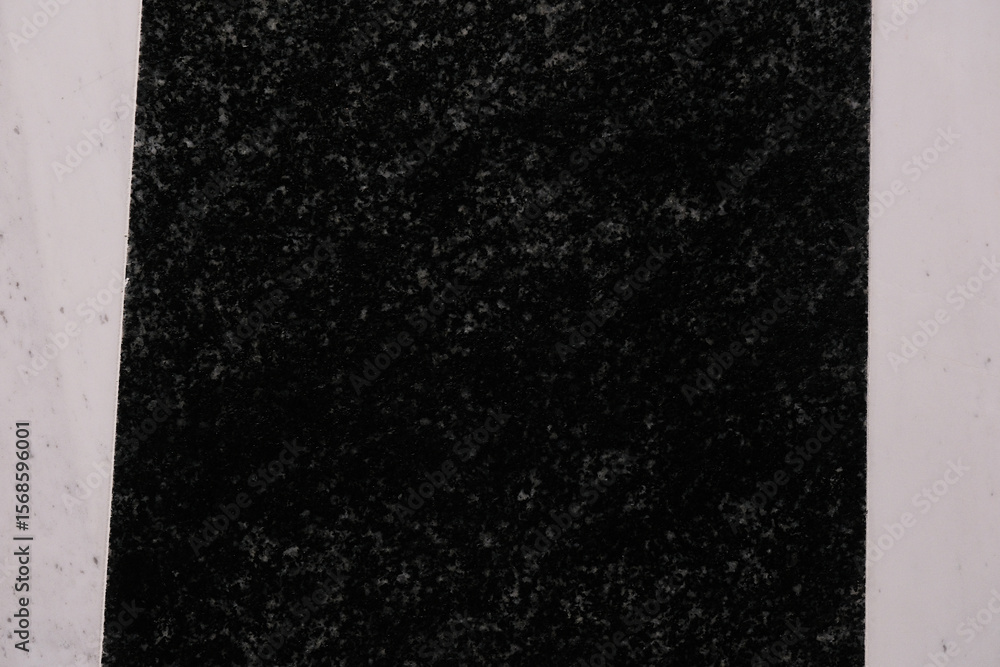 Poster a solid black speckled panel with a textured surface